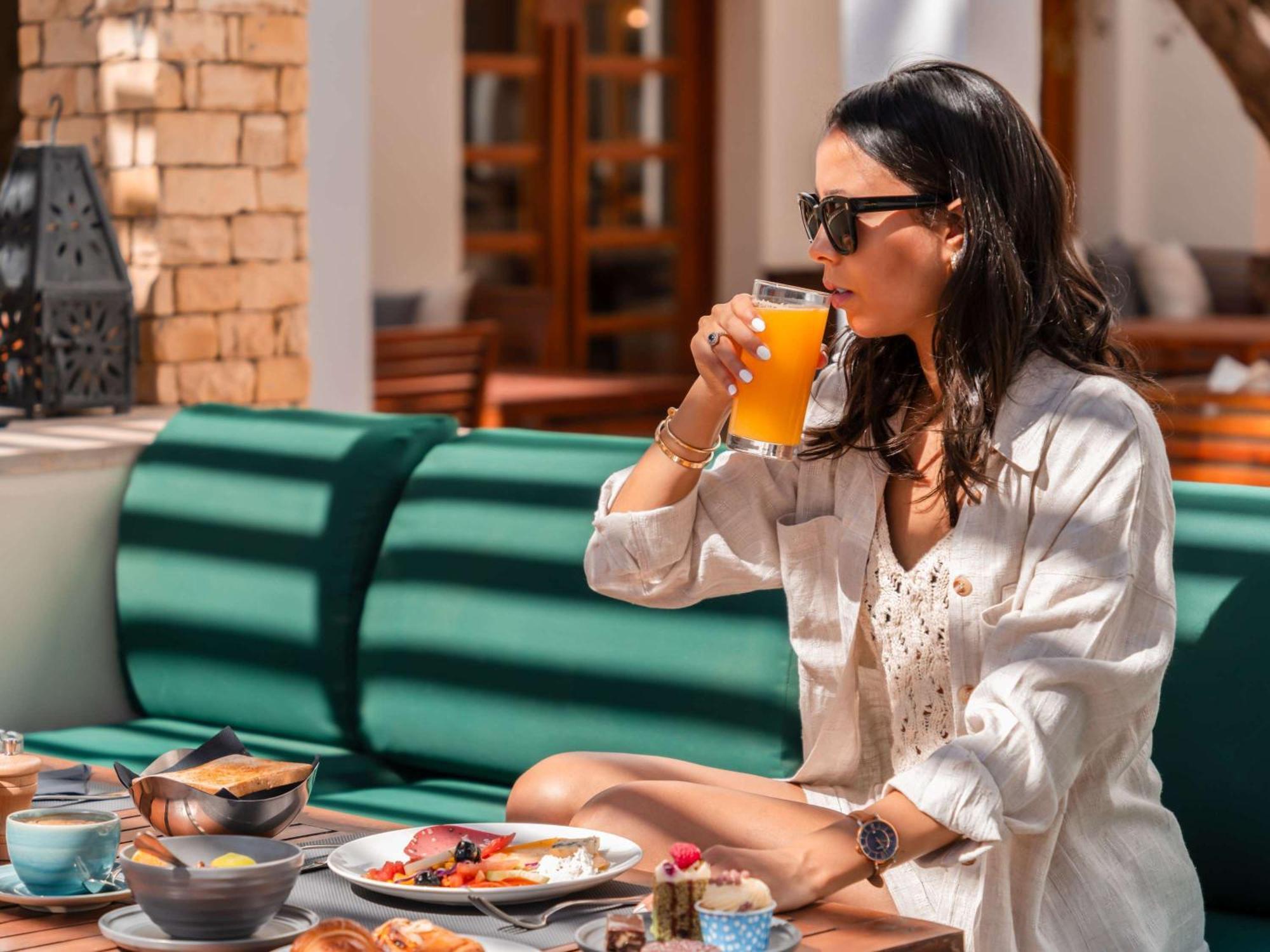 Sofitel Agadir Royal Bay Resort Exterior photo A woman drinking orange juice
